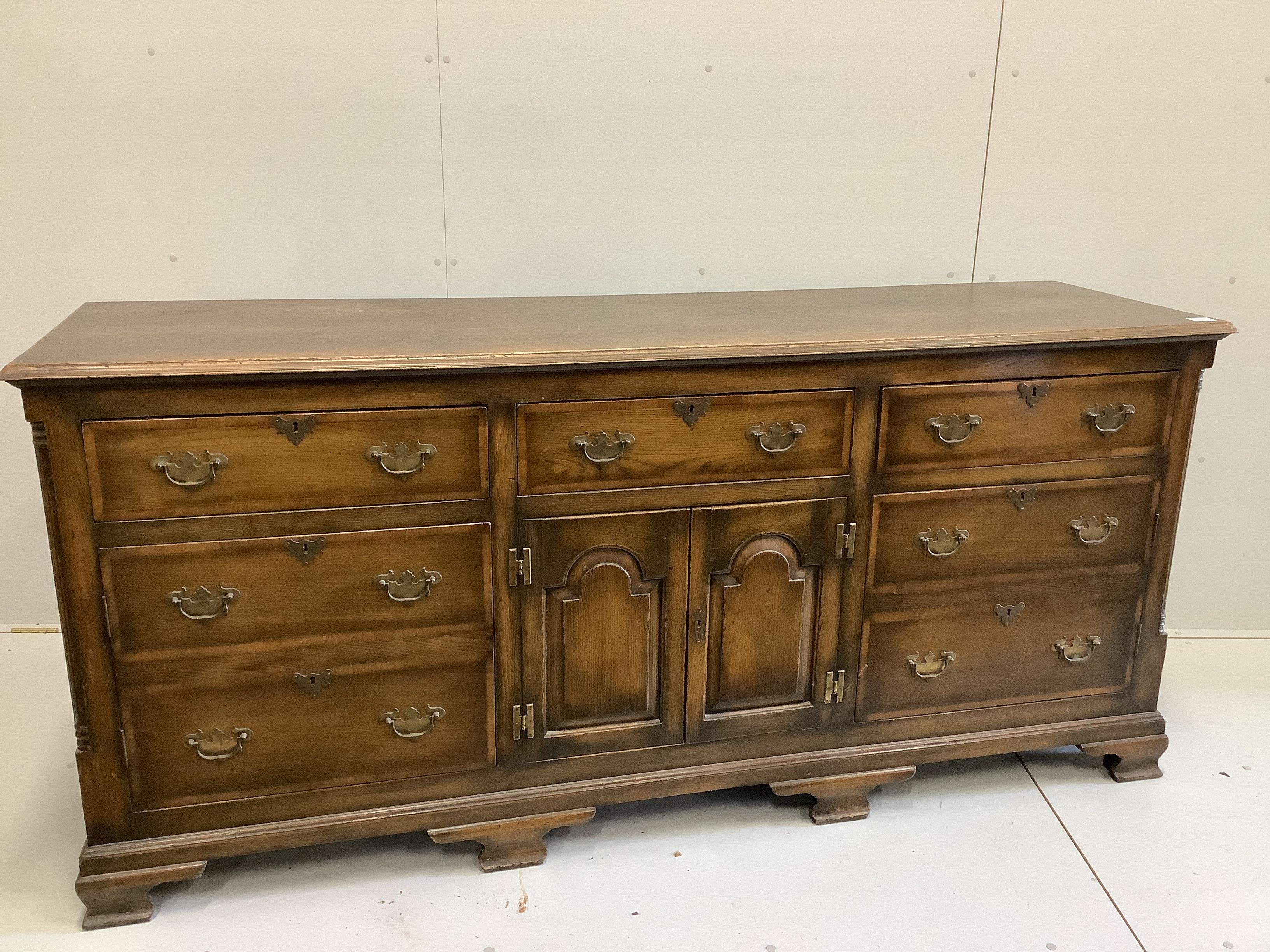 A reproduction 18th century style oak low dresser, width 196cm, depth 54cm, height 90cm